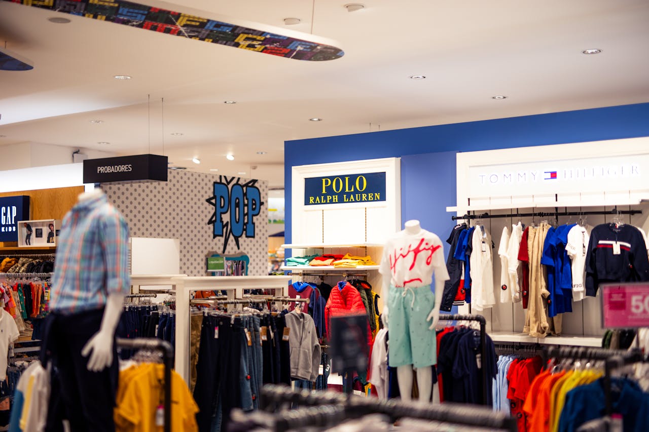 team-01 Vibrant clothing display at a modern retail store with mannequins featuring popular fashion brands.